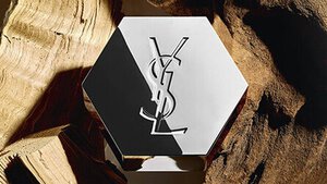 An elegant hexagonal bottle featuring a logo, placed against a background of wooden textures.