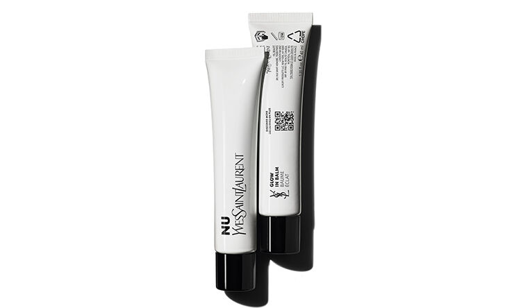 Two tubes of YSL skincare products are displayed against a white background. One tube is standing upright, while the other is tilted slightly to the side. The packaging features a sleek, modern design in black and white.