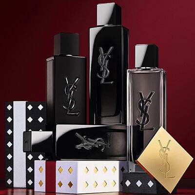 Yves Saint Laurent holiday collection gift sets and luxury beauty products displayed against a festive red background.