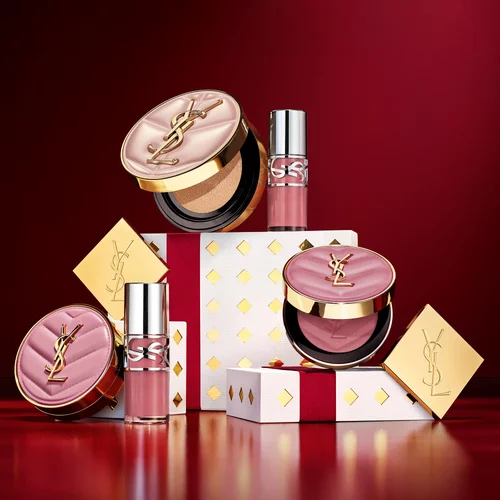 YSL makeup products arranged with festive gift boxes.