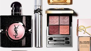 Flat lay of YSL beauty products including perfume, skincare, and makeup.