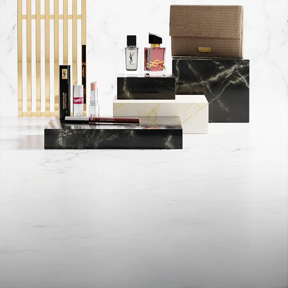 YSL beauty products on luxury marble plinths.