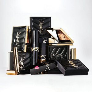 Luxury YSL beauty products in black and gold packaging arranged together.