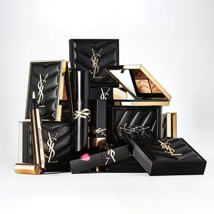 Luxury YSL beauty products in black and gold packaging arranged together.