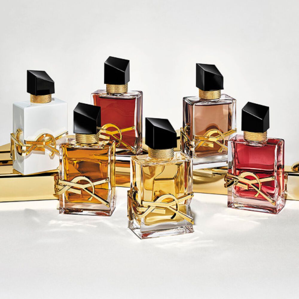 Collection of YSL Libre perfume bottles in various colors and finishes.