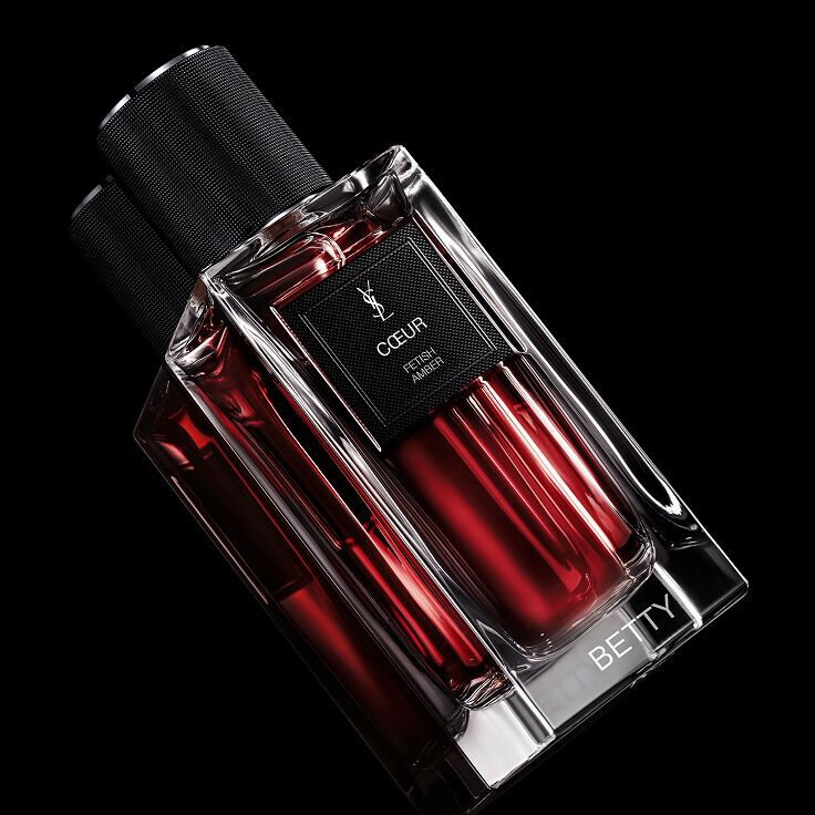 Close-up of the COEUR bottle demonstrating the YSL custom engraving and personalization service.