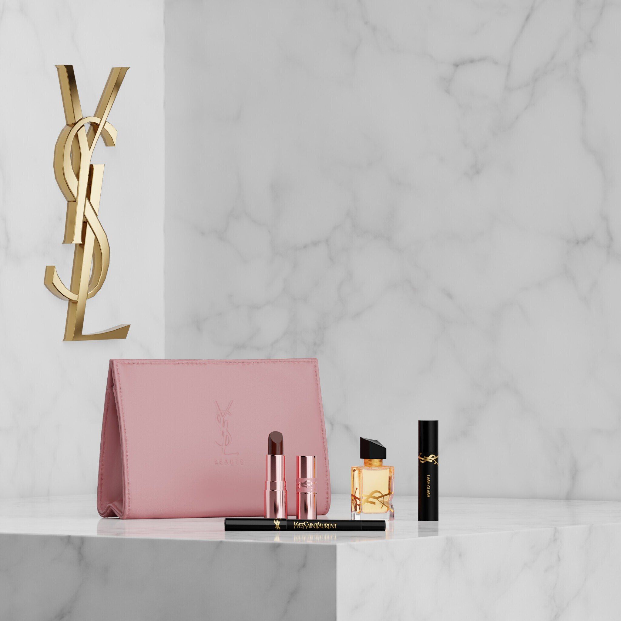 YSL Beauty makeup set with pink pouch, lipstick, eyeliner, mascara and mini fragrance on a marble shelf.
