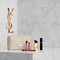 YSL pouch, Libre fragrance and makeup on a white marble background.