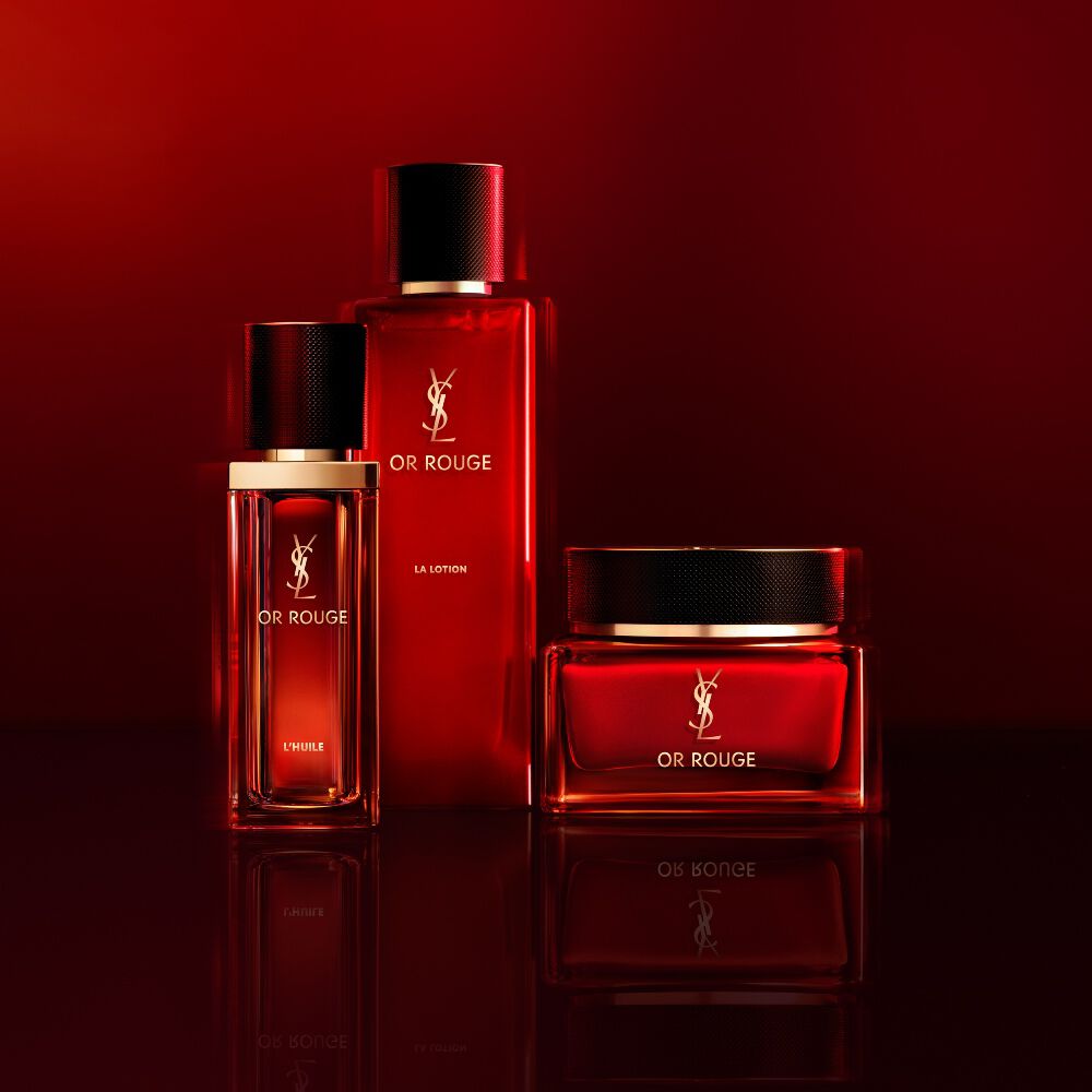 Two YSL Pure Shots skincare products, a bi-essence and an emulsion, set against a cactus with a blooming white flower.