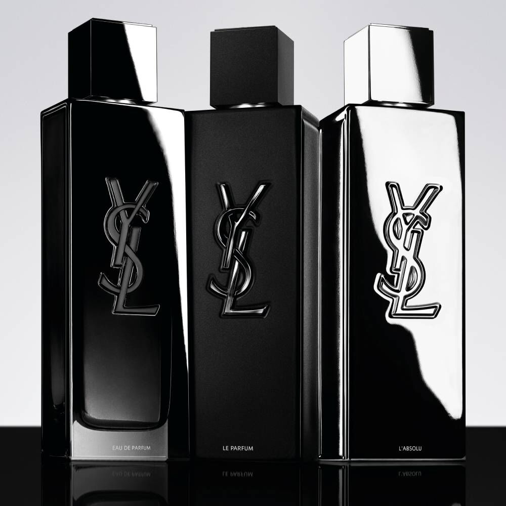 Three black YSL fragrance bottles on light background