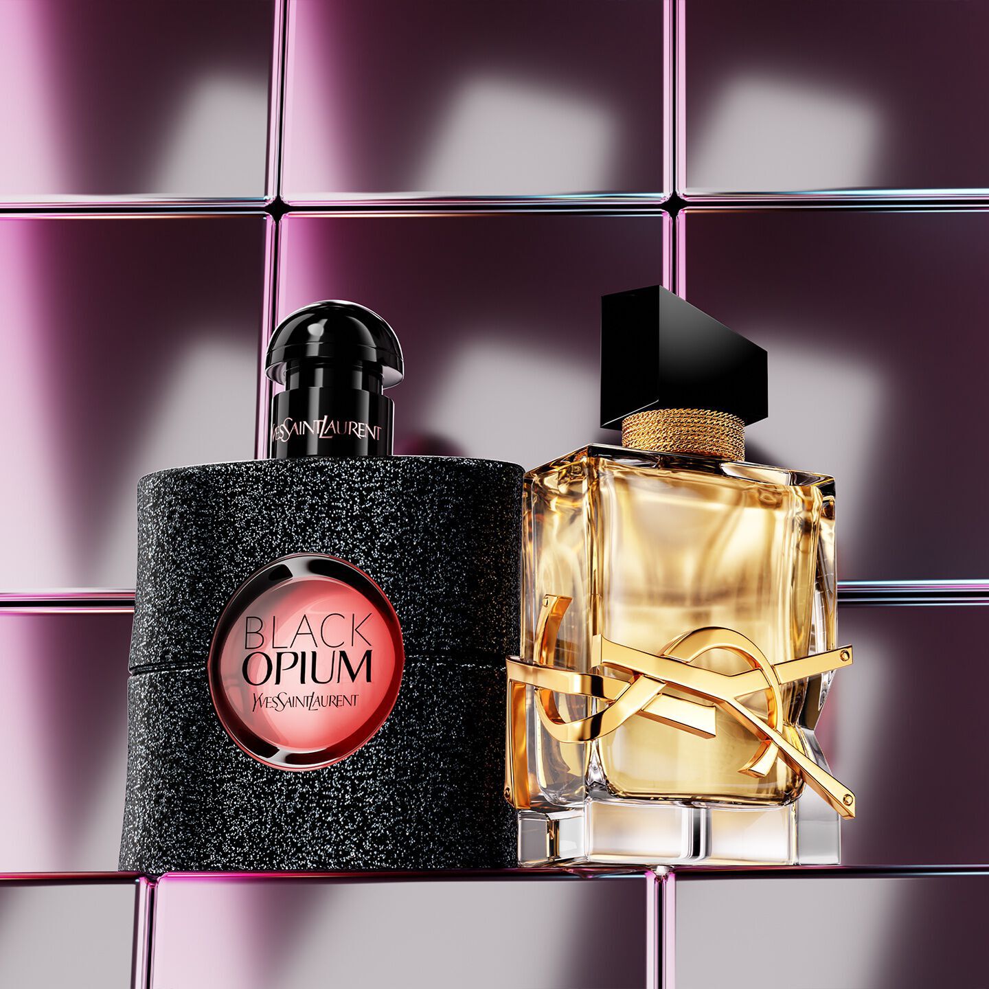 YSL beauty products including a quilted compact, mascara, and two lipsticks against a glossy pink tiled background.