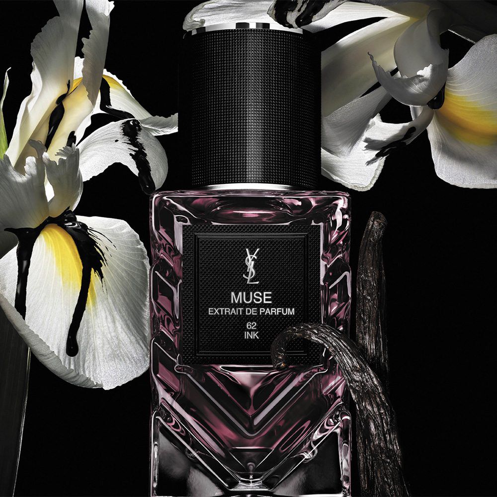 New Le Vestiaire des Parfums bottle on a black background with flowers behind it.