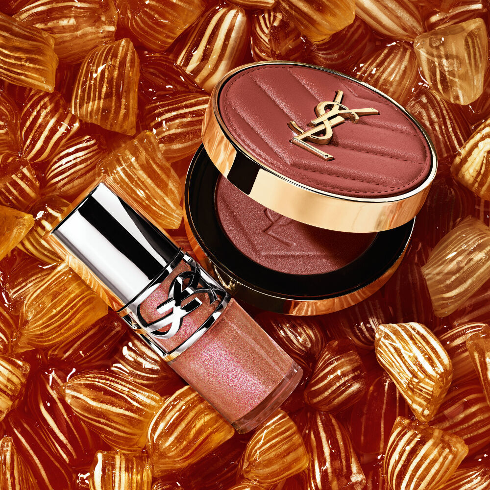 YSL LOVESHINE Plumping Lip Oil Gloss shade 12 and Make Me Blush shade 12, nestled among golden berlingot sweets.