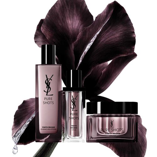 YSL Pure Shots skincare products in front of a dark flower backdrop.