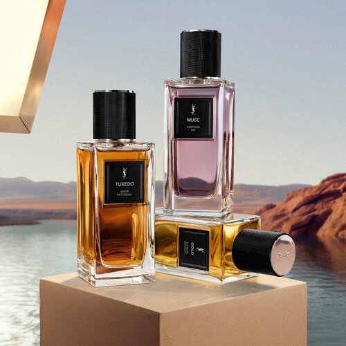 YSL fragrance bottles on a pedestal by the water