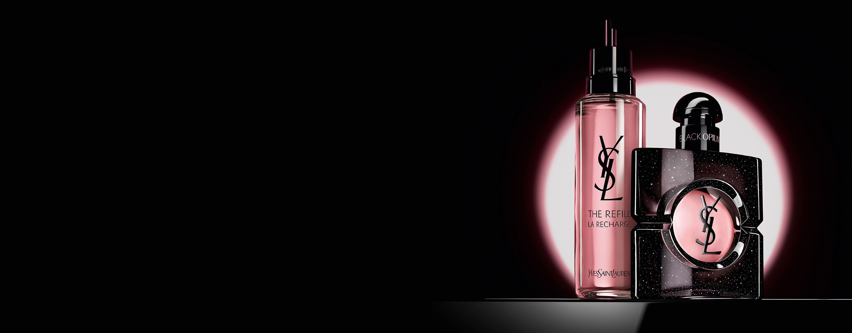 Black Opium Eau de Parfum bottle shown next to its 100ml glass refill bottle with the YSL logo.