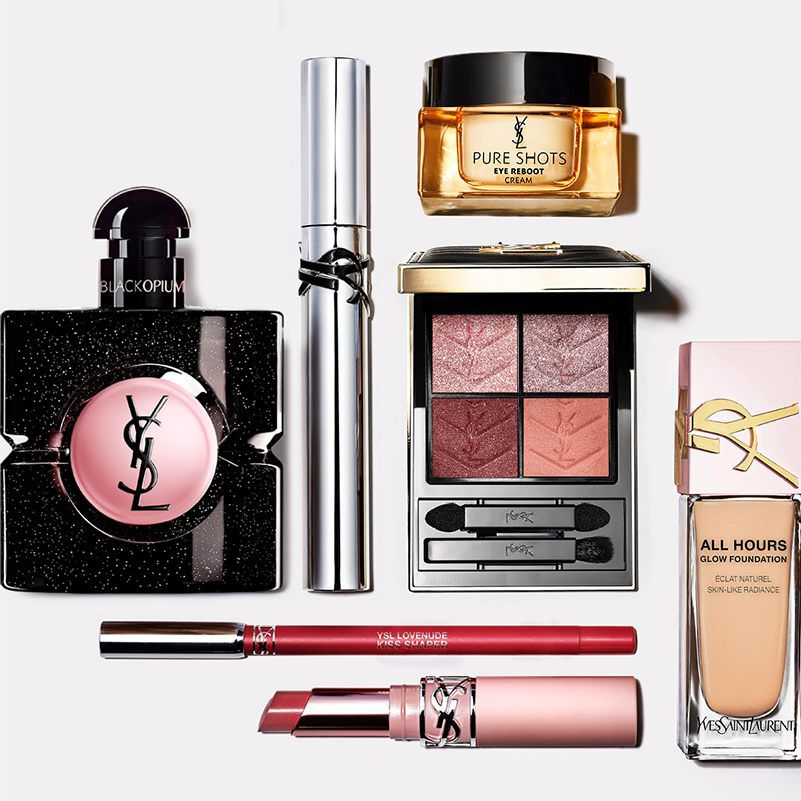 Flat lay of YSL beauty products including perfume, skincare, and makeup.