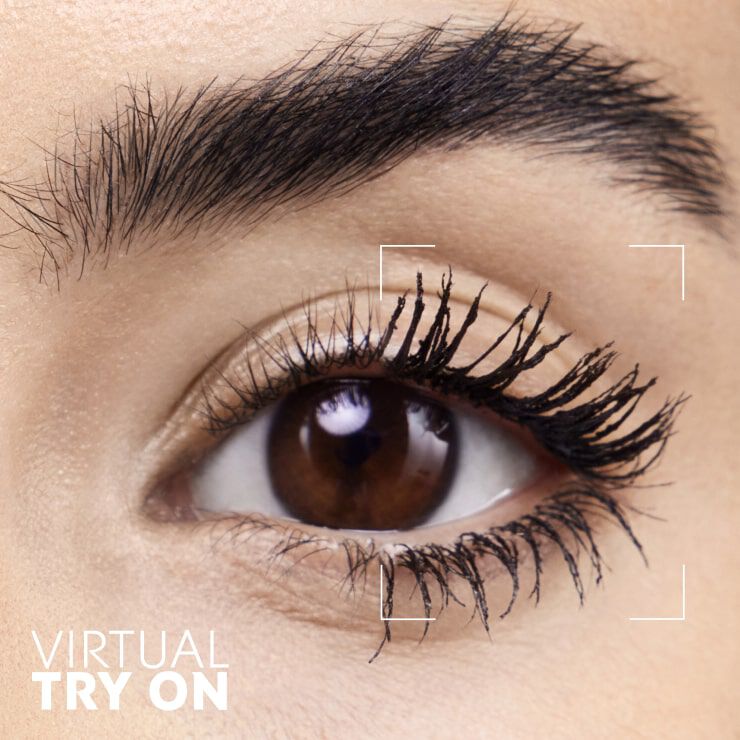 A close-up of a person's eye showcasing long, defined eyelashes, with a graphic overlay that reads "VIRTUAL TRY ON" in the bottom left corner.