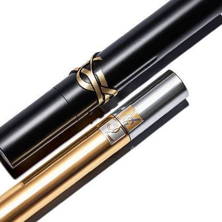 A black and a gold tube lying diagonally on a white background, with the gold tube featuring a decorative logo.
