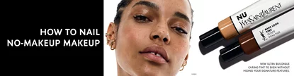 A close-up of a model showcasing a natural makeup look, with focus on her radiant skin and minimal makeup. The image features beauty products from YSL on the right side, promoting a no-makeup makeup style.