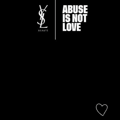 Logo of Yves Saint Laurent next to the phrase "ABUSE IS NOT LOVE" on a black background, with a small heart icon at the bottom.