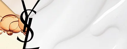 An abstract image featuring a splash of liquid with bubbles and a smooth white texture, alongside the bold letters "YSL" in black.