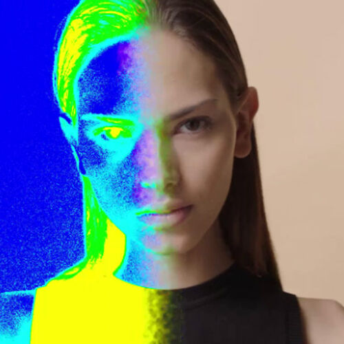 A split image of a woman’s face, half in natural colors and half stylized with blue and yellow digital effects, creating a striking contrast.