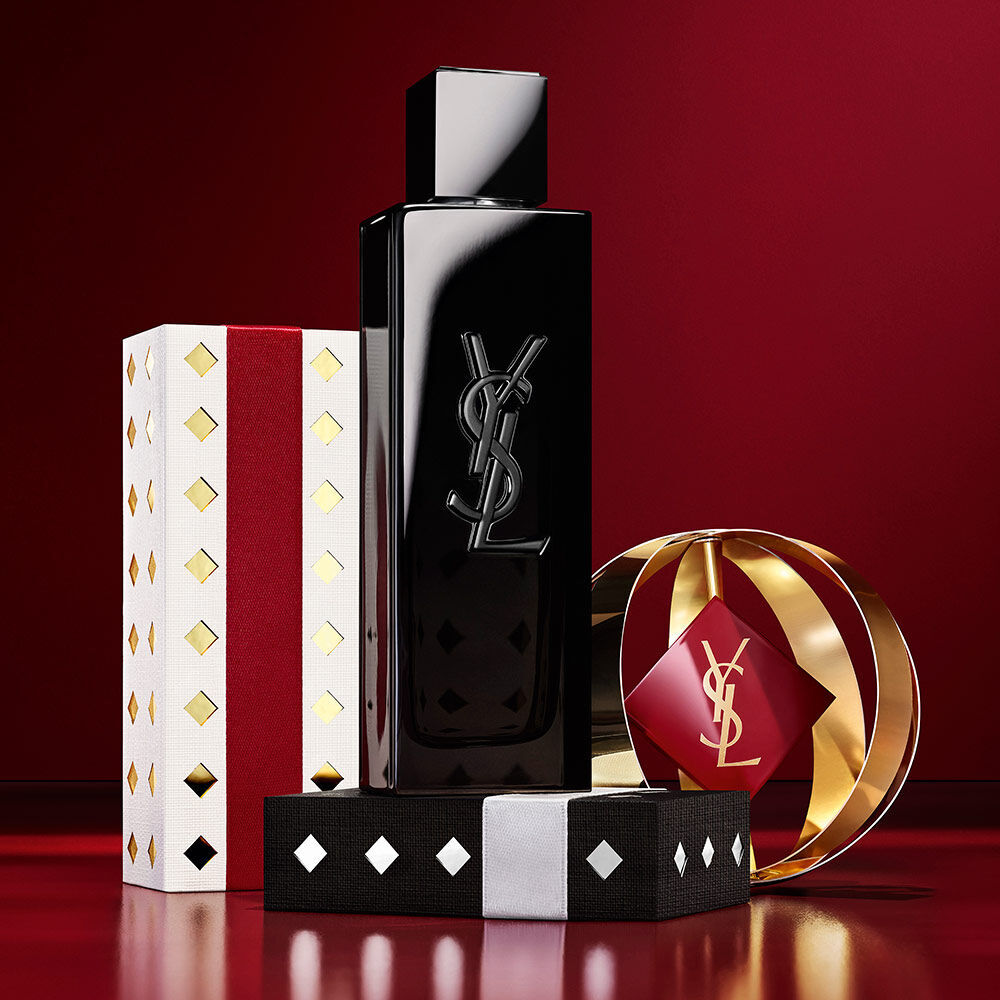 MYSLF fragrance bottle displayed with gold and burgundy YSL Holiday gift packaging.