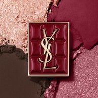 YSL Couture Mini Clutch palette set against a textured background of shimmering eyeshadow powders of #1982 Burgundy Millesime.
