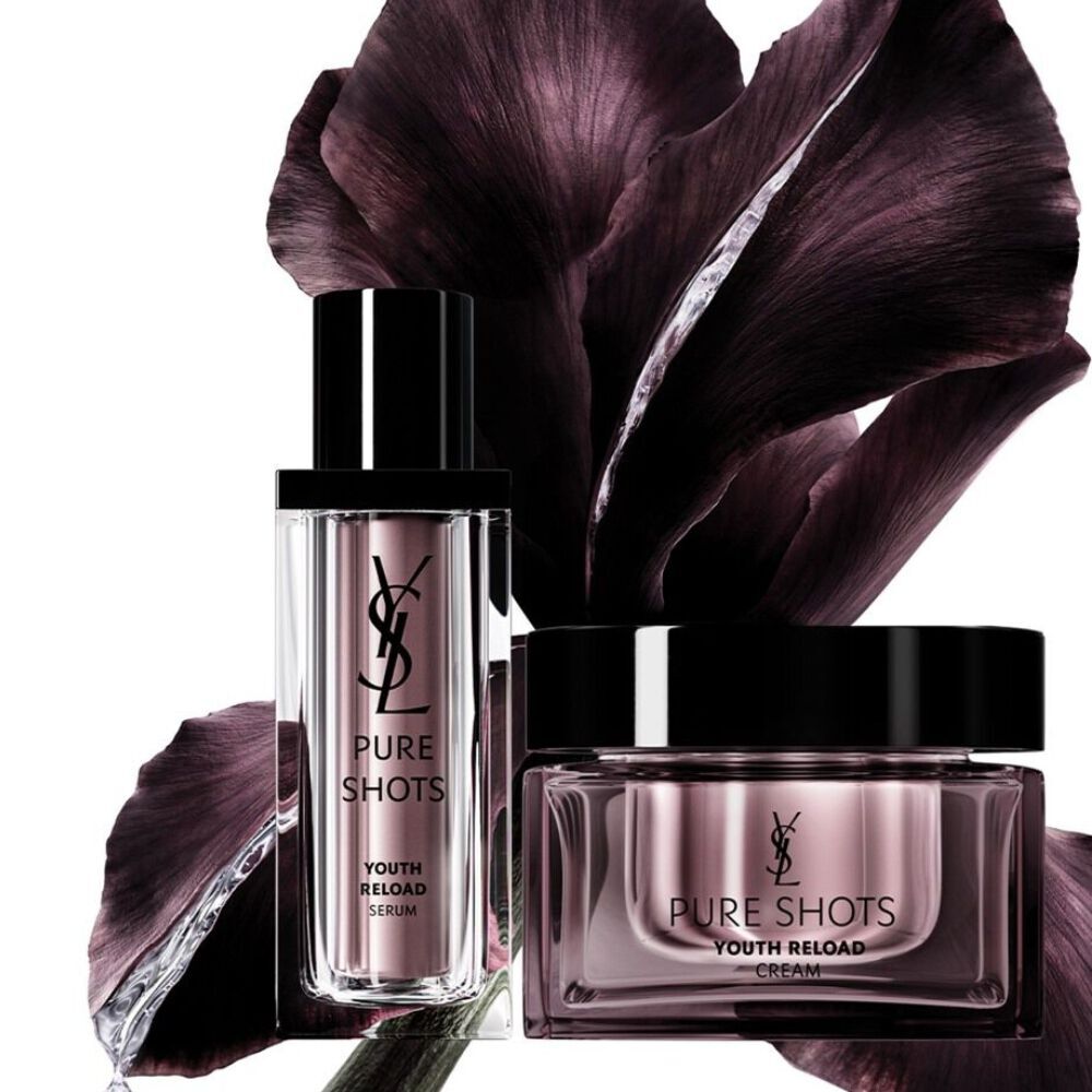 Two purple skincare products with dark flower petals