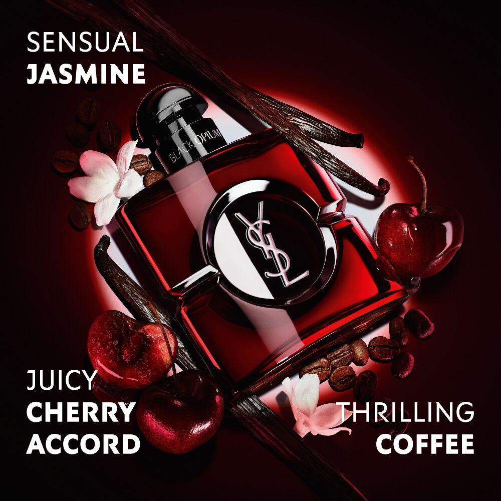 Black Opium Over Red bottle in deep red lacquer surrounded by fresh red cherries and coffee beans with claims.