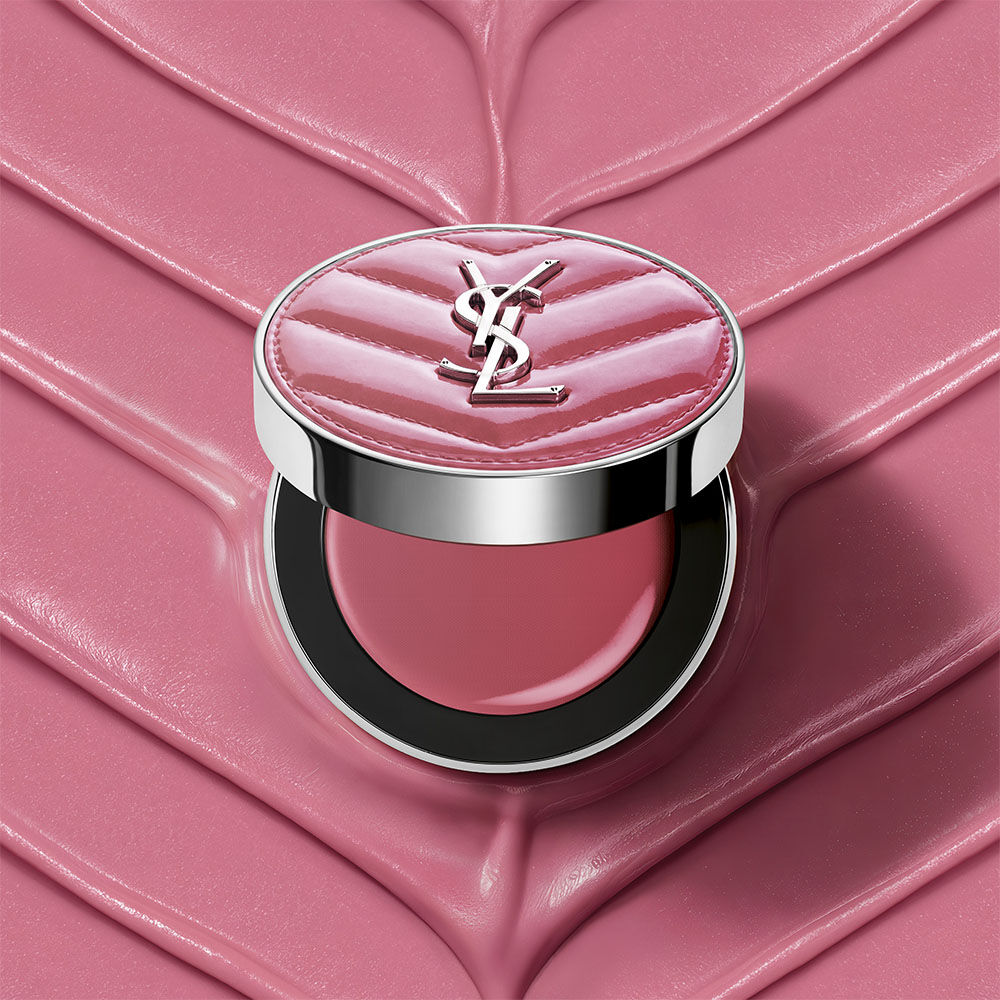 An open YSL Make Me Blush Lifted Glow Cream Blush compact in shade #44 Nude Lavalliere on a matching pink textured cream background.
