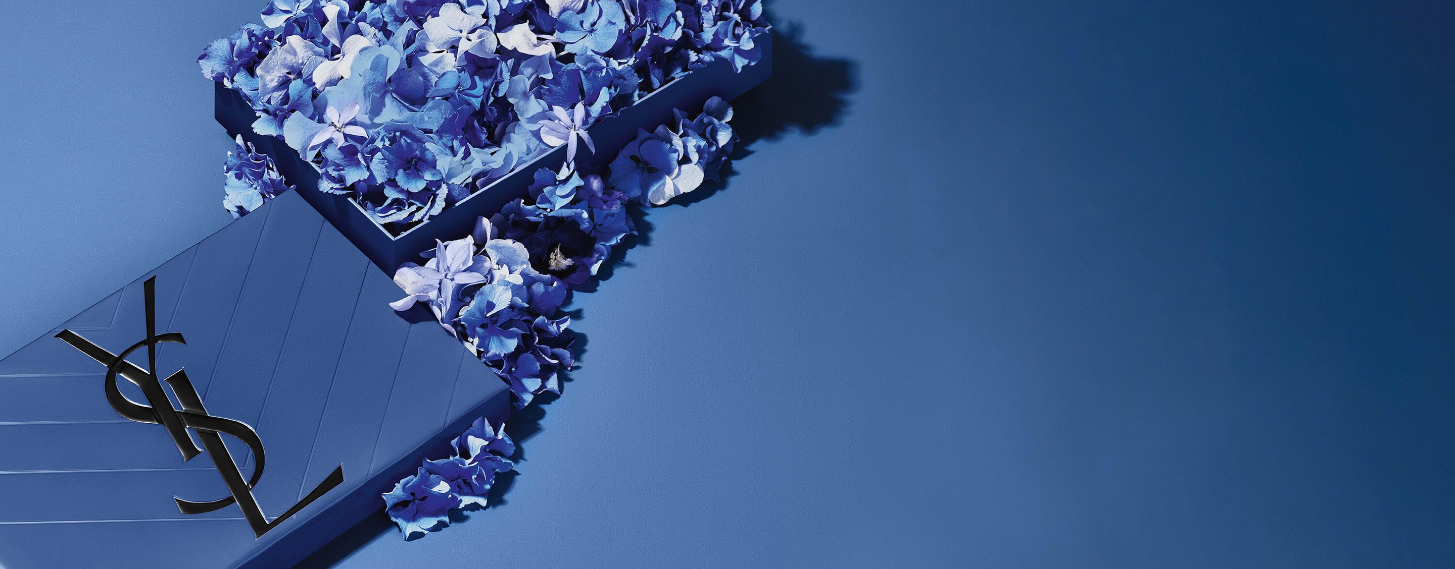 YSL Father's Day blue gift set, featuring the iconic
Cassandre logo, overflowing with delicate blue floral
accents.