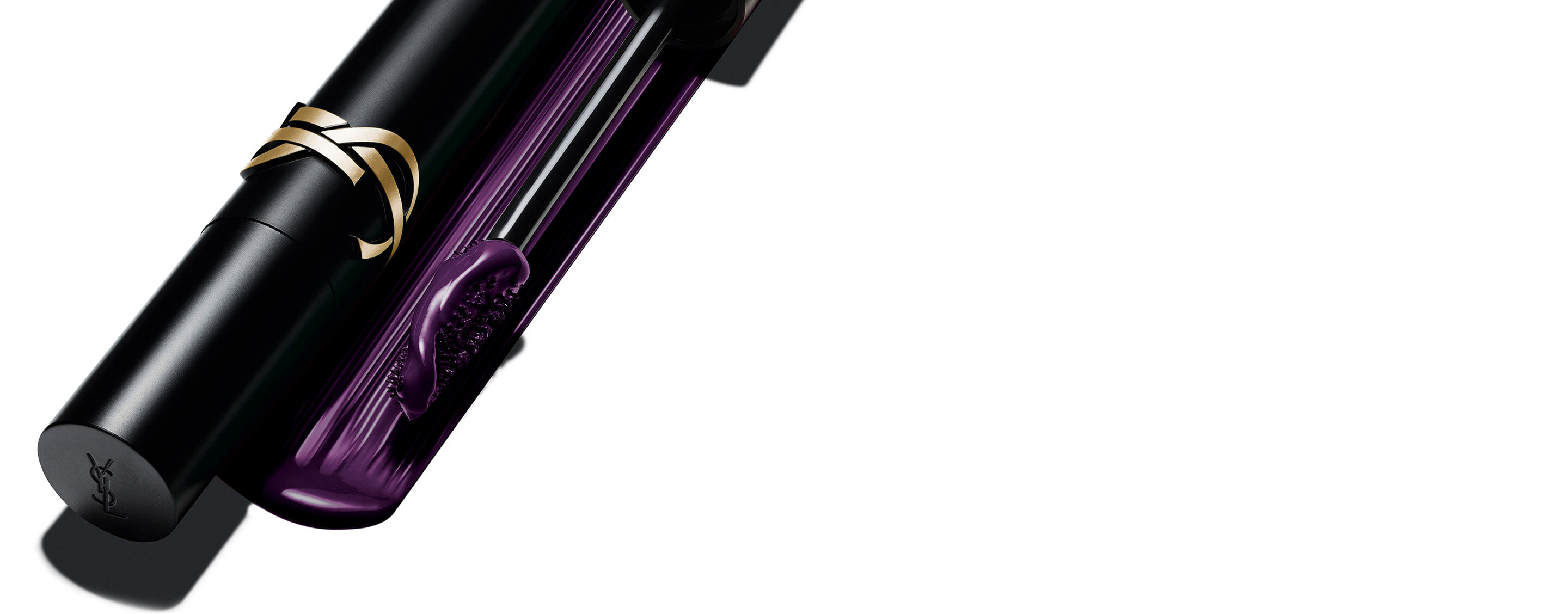 Yves Saint Laurent Lash Clash Mascara in plum, featuring the black tube with gold YSL logo and the brush showing the purple texture.