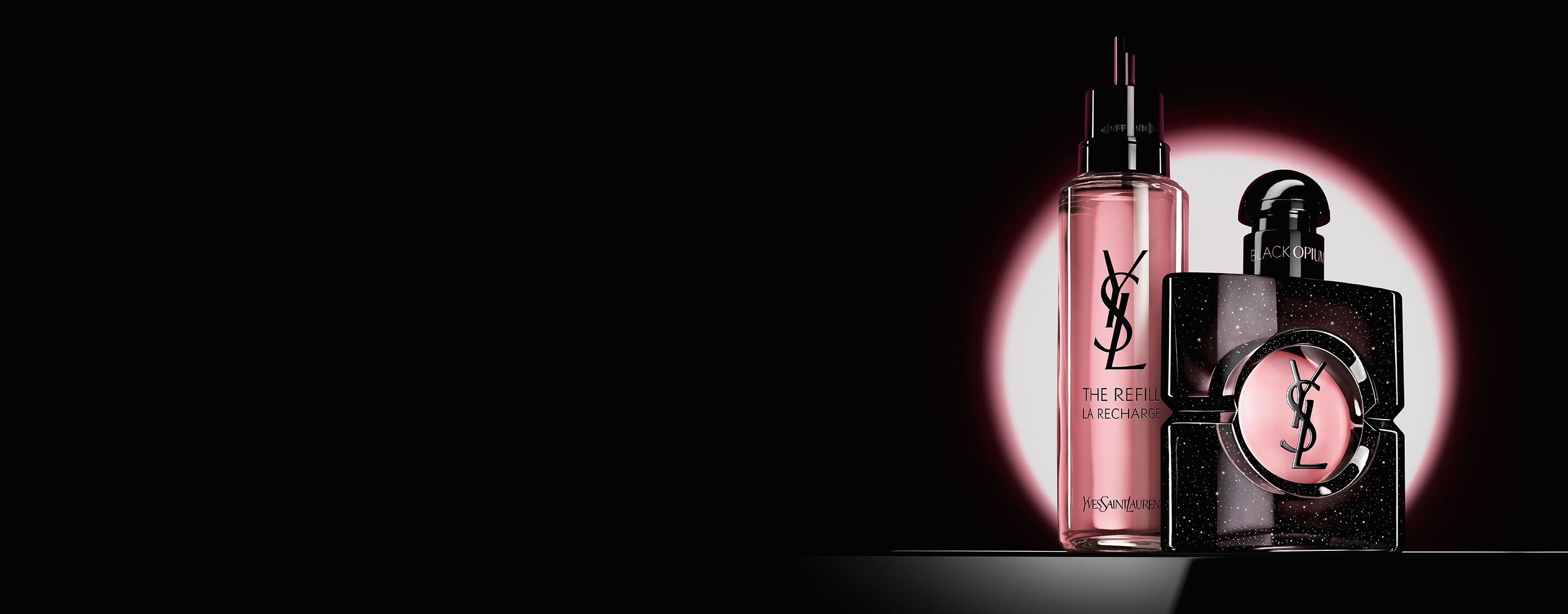 Black Opium Eau de Parfum bottle shown next to its 100ml glass refill bottle with the YSL logo.