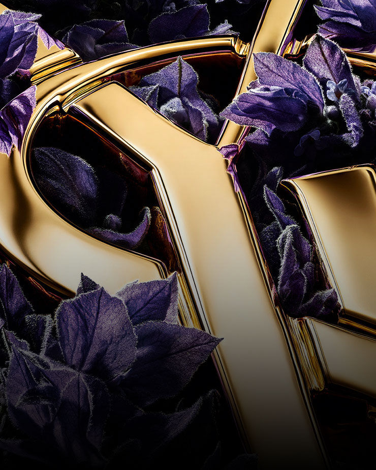 Rich purple lavender blooms highlighting the sharp, golden edges of the YSL logo.