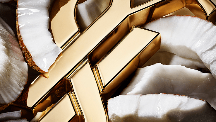 Close-up of YSL logo surrounded by white coconut pieces.