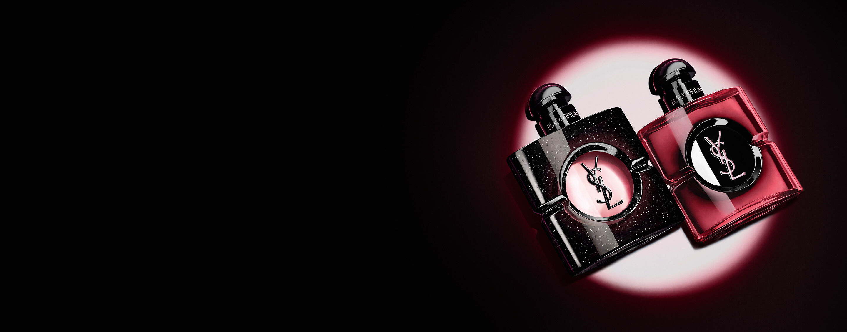 Two
                Black Opium perfume bottles, one black glitter: Eau de Parfum and one pink: Pink
                Glaze, placed side by side.