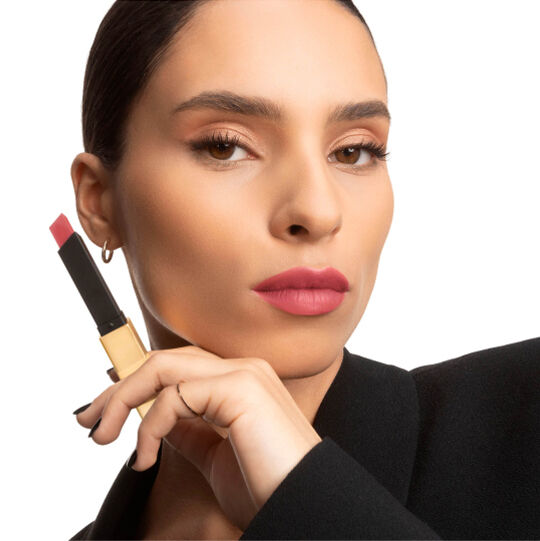 Two hands displaying YSL square lipsticks, one open and one closed.