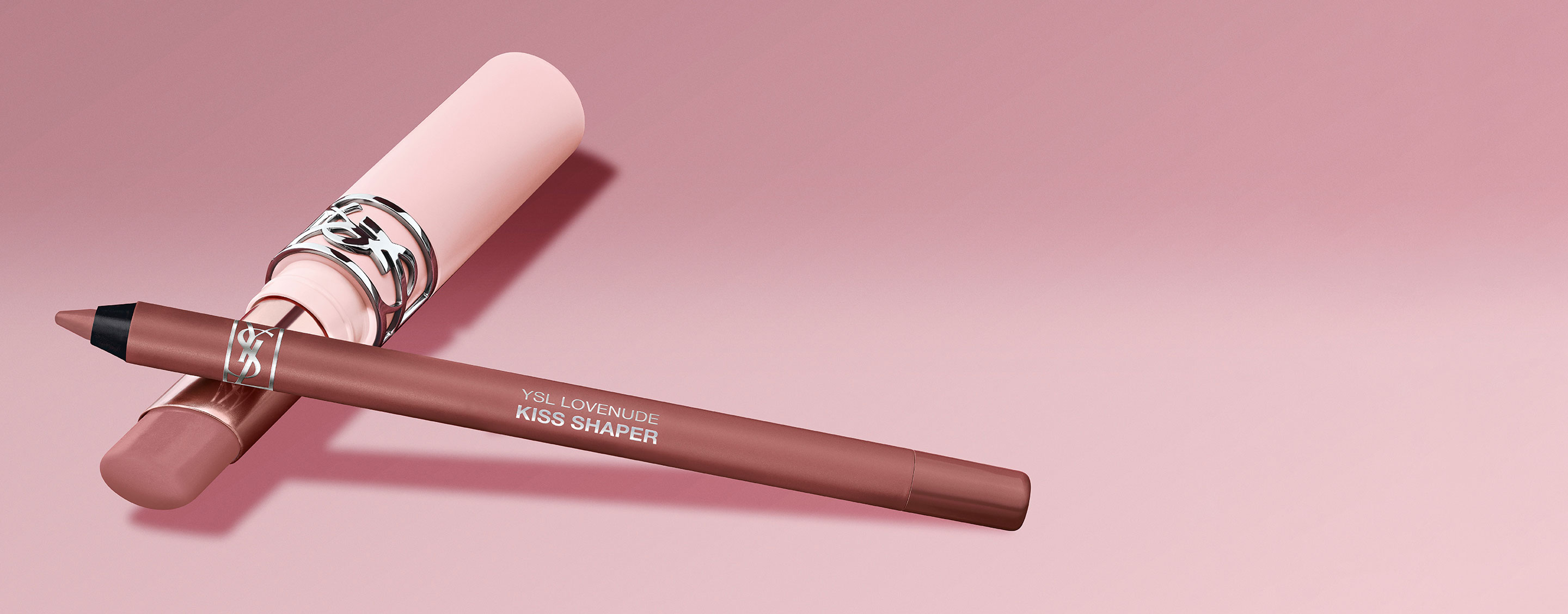 YSL Kiss Shaper lip pencil and matching lip product on a pink background.