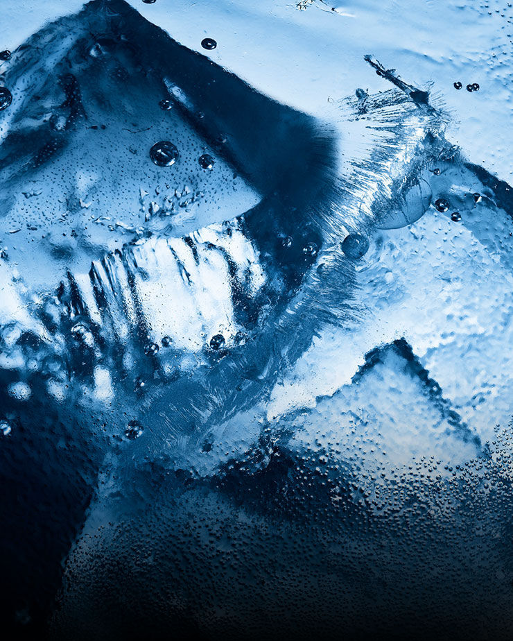 Close-up of ice and water droplets, evoking the intense, icy freshness of YSL Y Eau de Toilette Intense Iced Cologne.