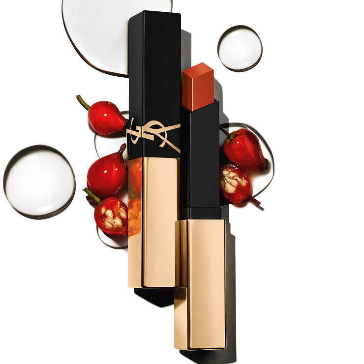 YSL square lipstick with gold cap amid red berries and clear drops on white.