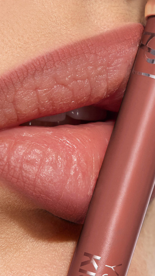 Vertical close-up of lips with mauve matte lipstick and a matching YSL lip pencil.