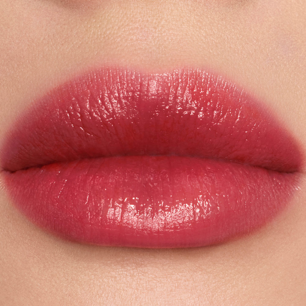 Close-up lip swatches of YSL vinyl-shine color stains in shades #445 Ring Me Pink.