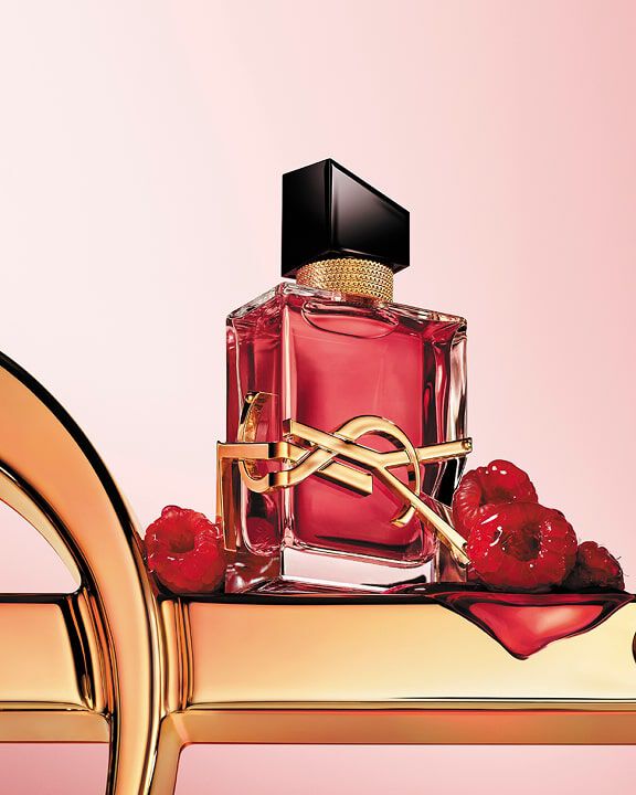 YSL logo surrounded by raspberries, white and purple flowers, and coconut.