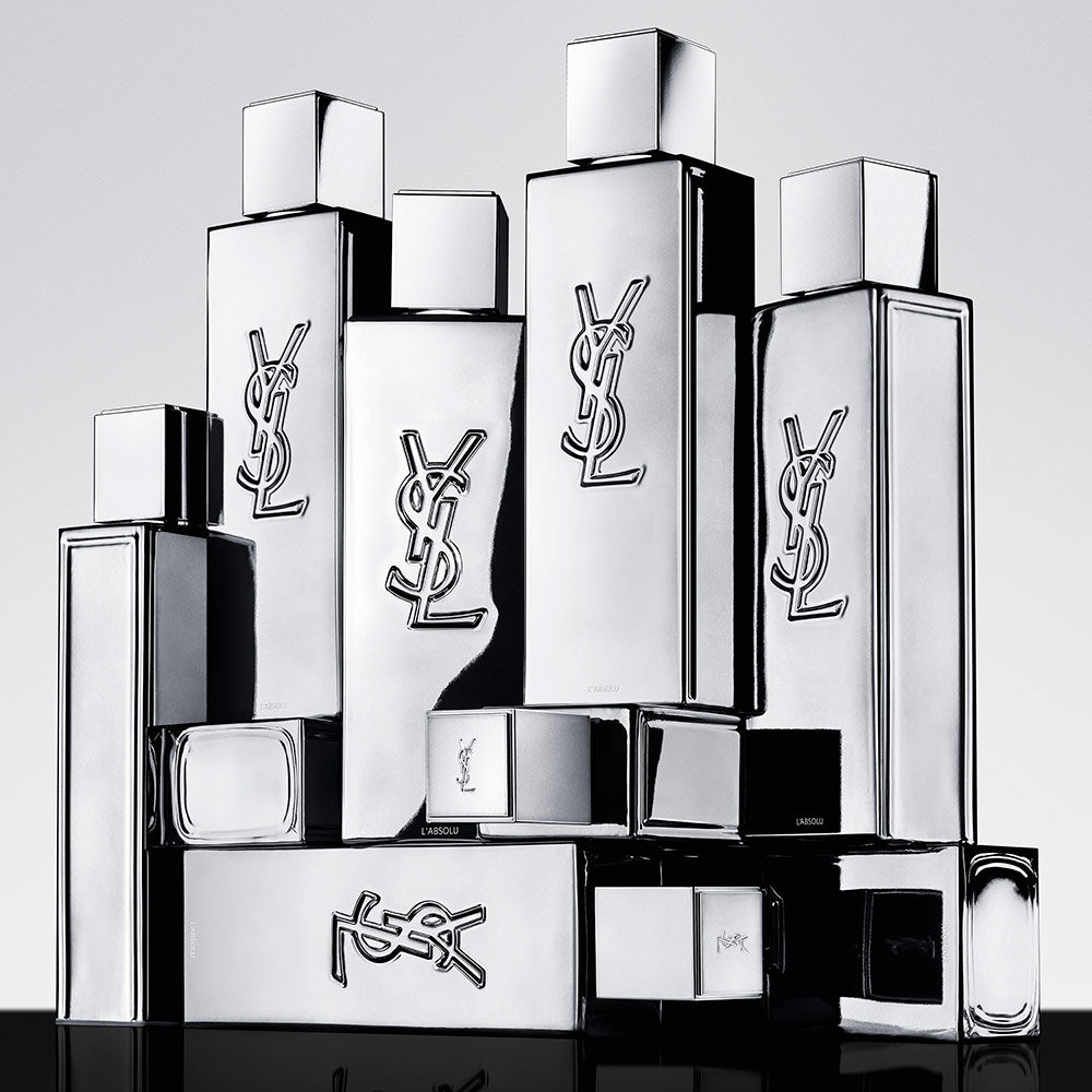 Stacked silver YSL L'ABSOLU perfume bottles.